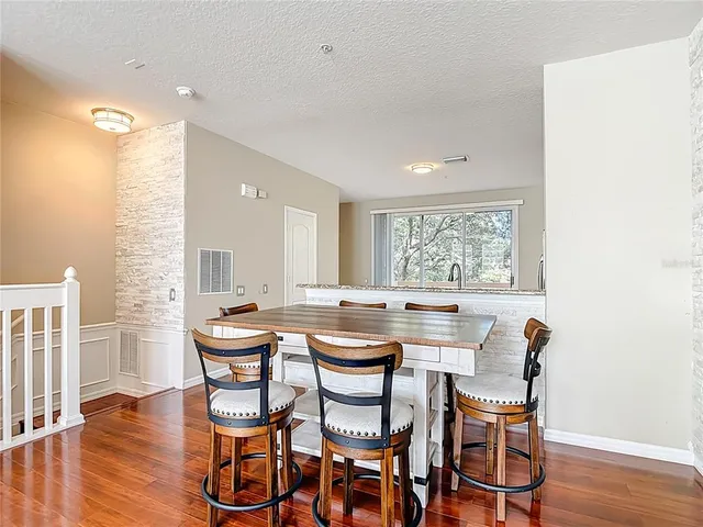 a dining room with furniture and wooden floor