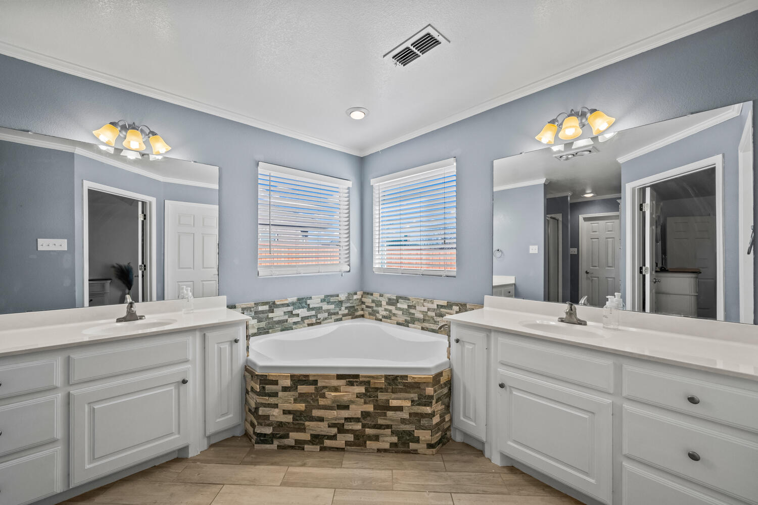 2605 Madison Street Lubbock, TX 79415 - Photo 12 of 23 a bathroom with a double vanity sink mirror and next to a window