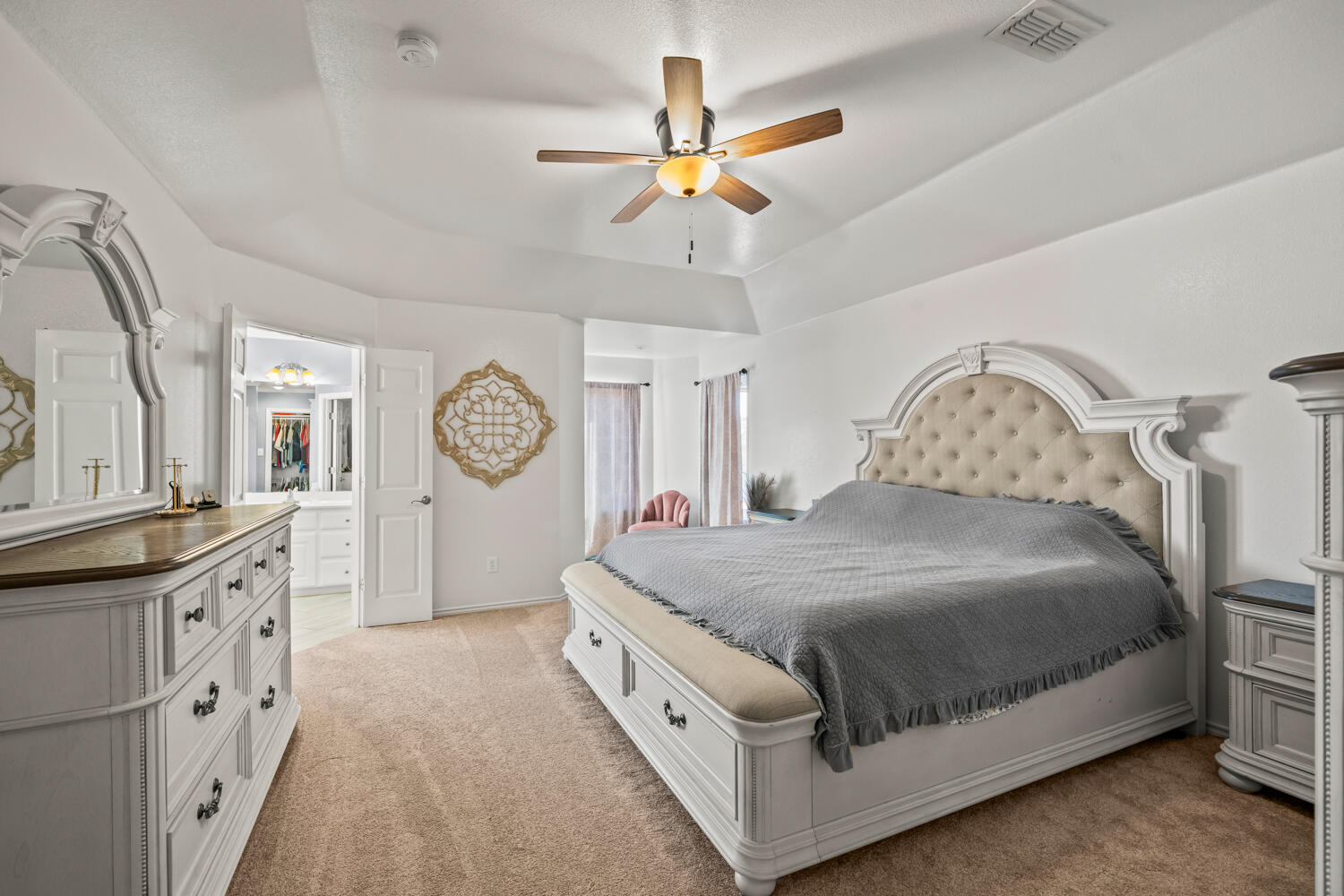 2605 Madison Street Lubbock, TX 79415 - Photo 10 of 23 a bedroom with a bed and a chandelier