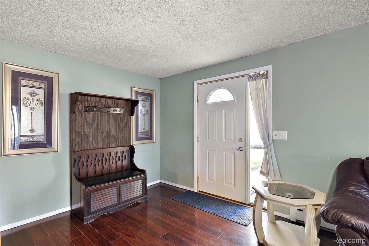 4705 Ketchum Road St. Clair, MI 48079 - Photo 15 of 58 Entryway featuring a textured ceiling and dark wood-style floors