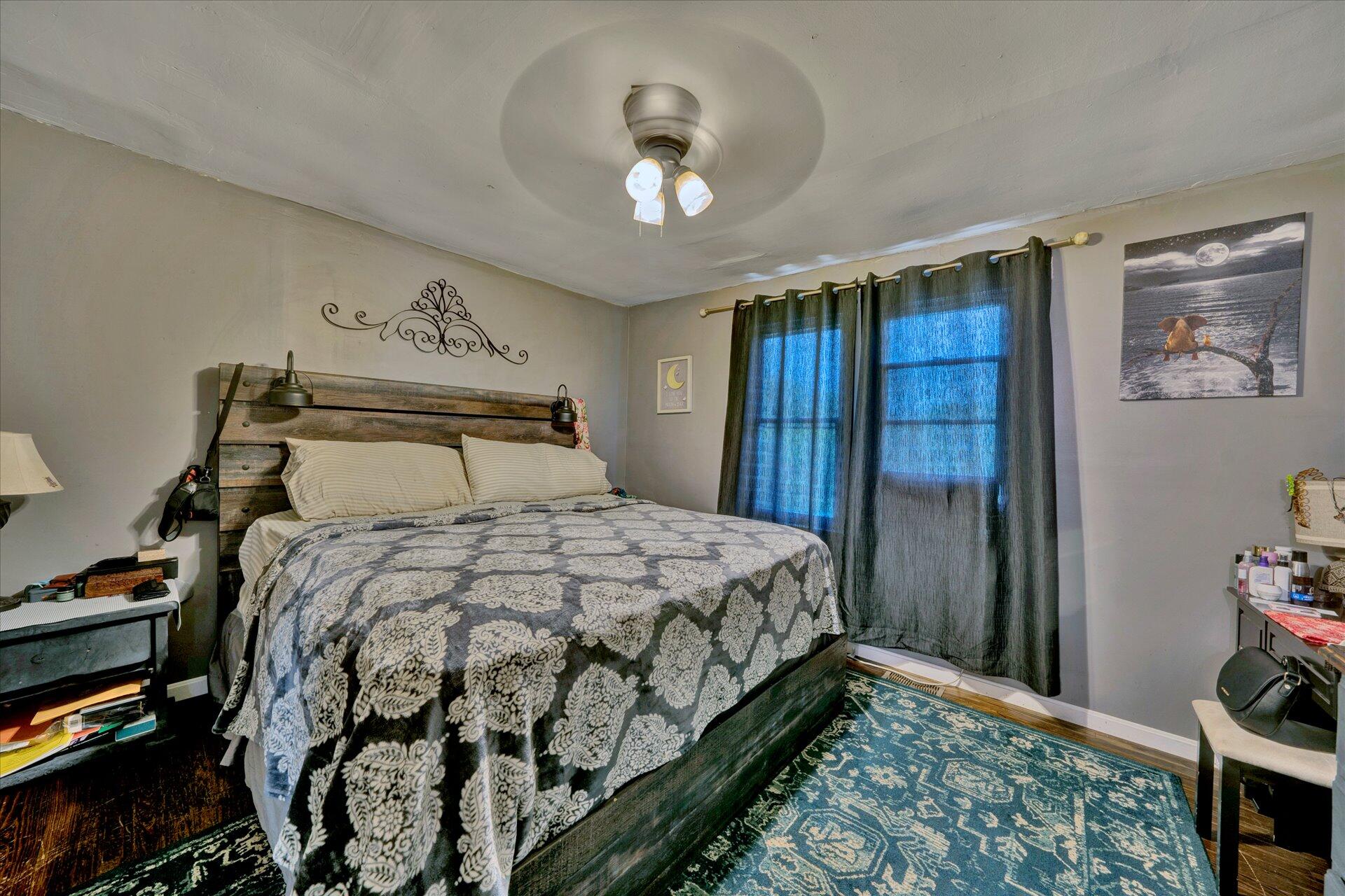 1344 Skyview Road Salem, VA 24153 - Photo 16 of 23 a bedroom with a bed and a chandelier