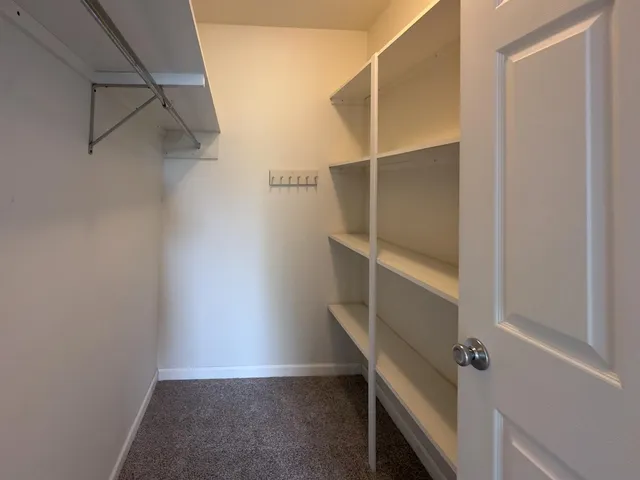 an aerial view of a house with a yard and lake view