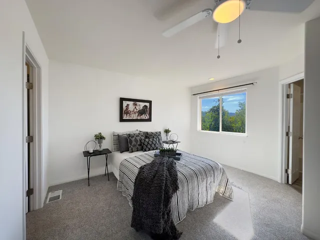 a bedroom with a bed and a large window