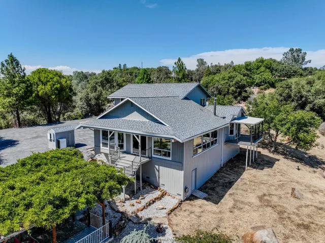 a kitchen with stainless steel appliances a stove a sink a refrigerator and chairs