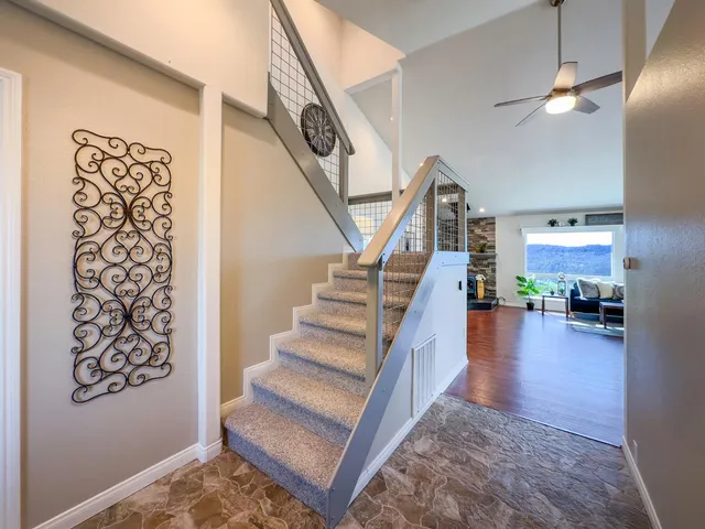 a bedroom with a bed and ceiling fan
