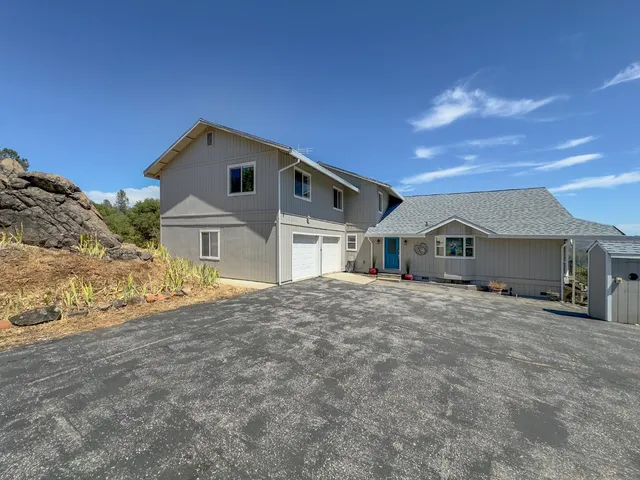 a bathroom with a granite countertop sink and a bathtub