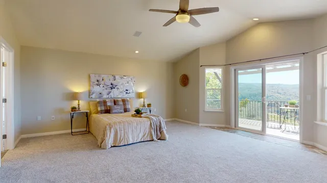 a living room with pool table and windows
