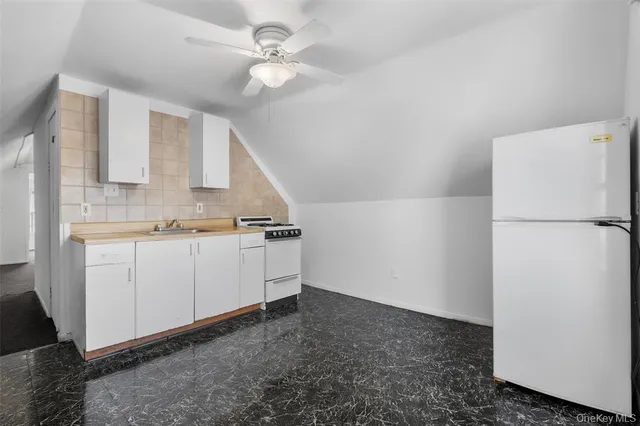 a kitchen with a stove and white cabinets