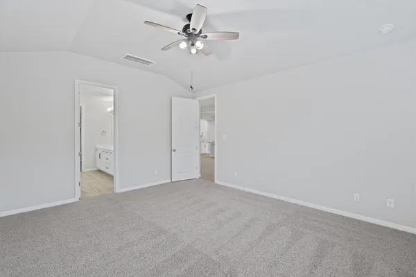 a view of an empty room with a ceiling fan