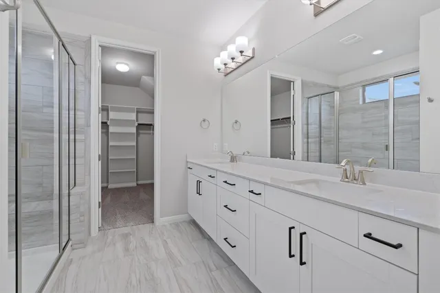 a bathroom with a glass shower door