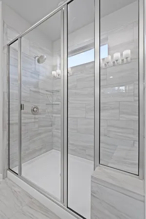 a bathroom with a glass shower door