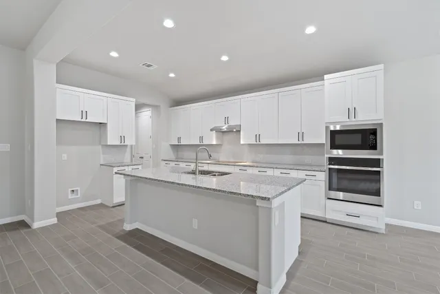 a kitchen with sink cabinets and wooden floor