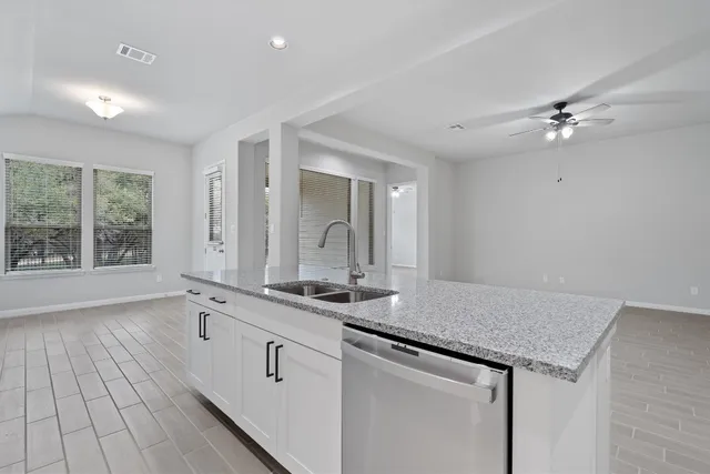 a kitchen with white cabinets and a sink