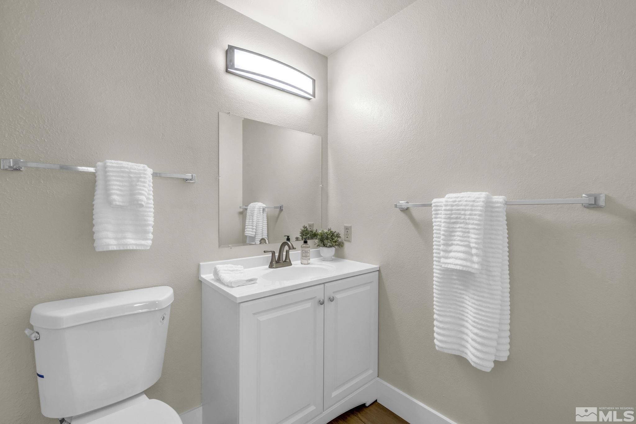 13 Condor Circle Carson City, NV 89701 - Photo 18 of 33 a bathroom with a toilet sink vanity and mirror