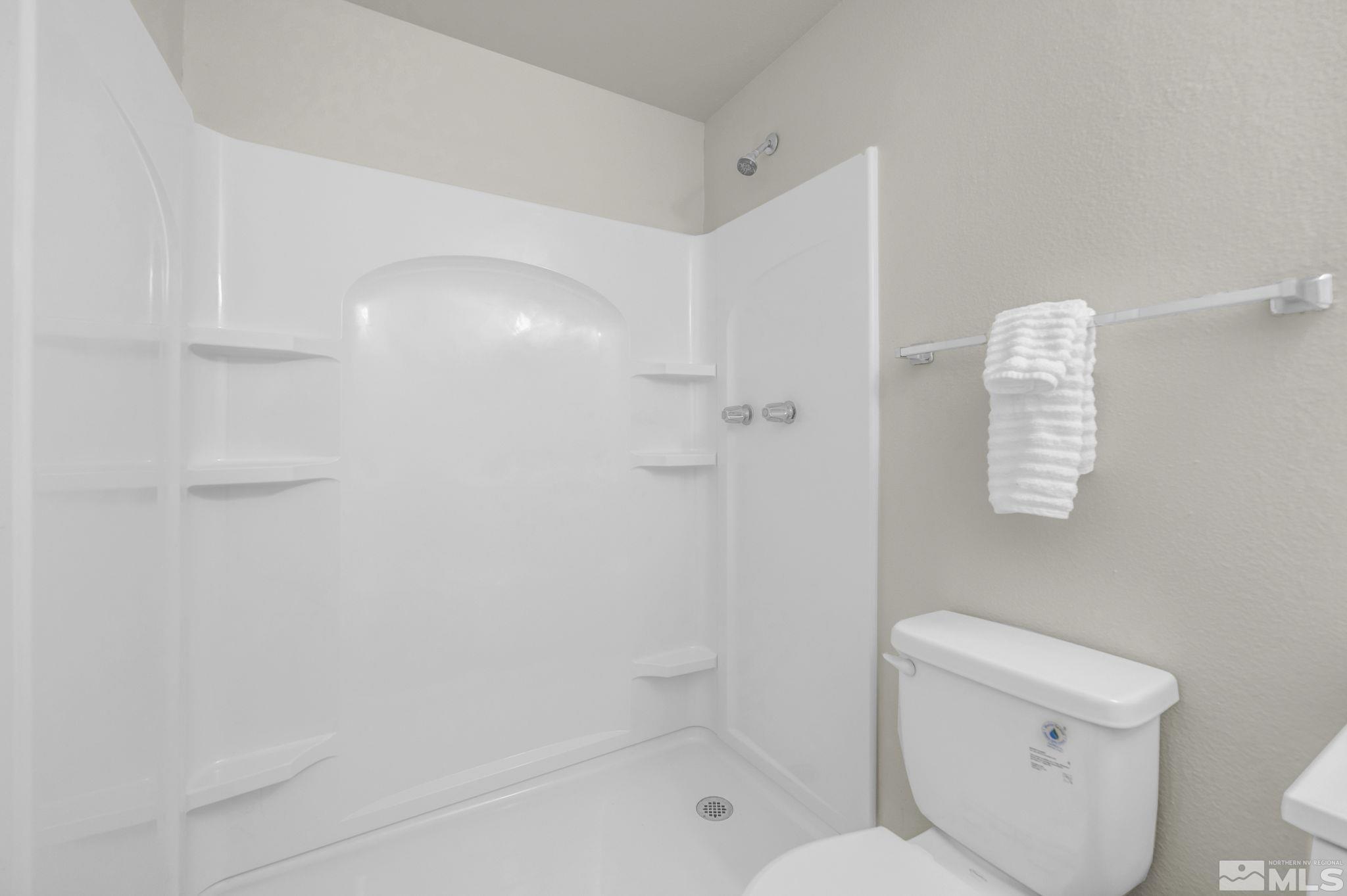13 Condor Circle Carson City, NV 89701 - Photo 25 of 33 a white toilet sitting next to a bath tub shower