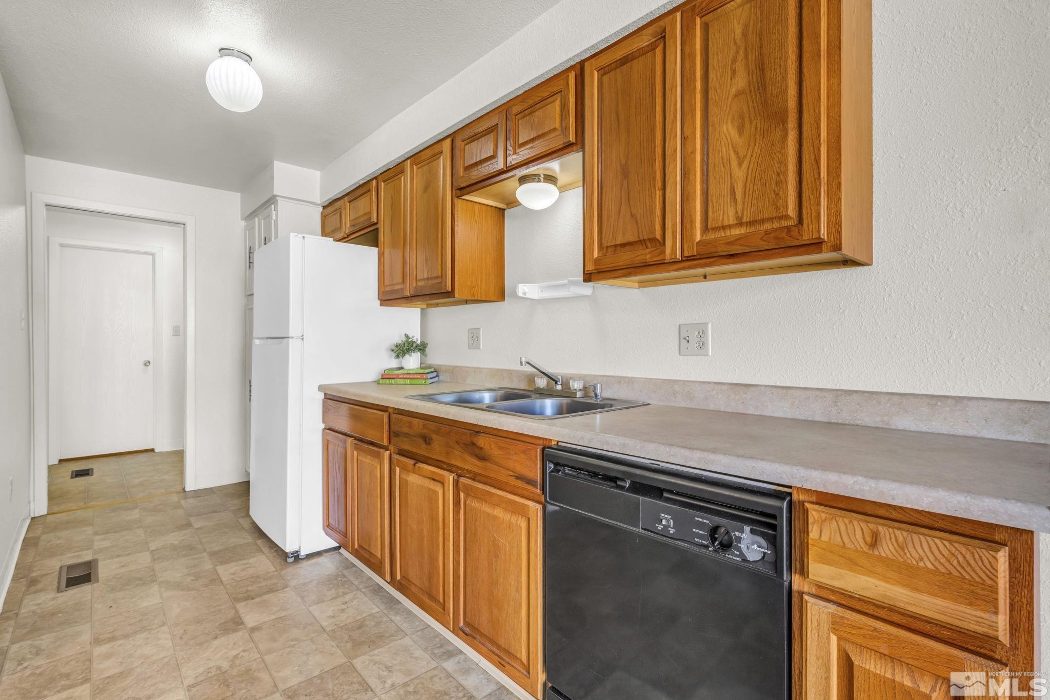 13 Condor Circle Carson City, NV 89701 - Photo 4 of 33 a kitchen with stainless steel appliances granite countertop a sink stove and cabinets