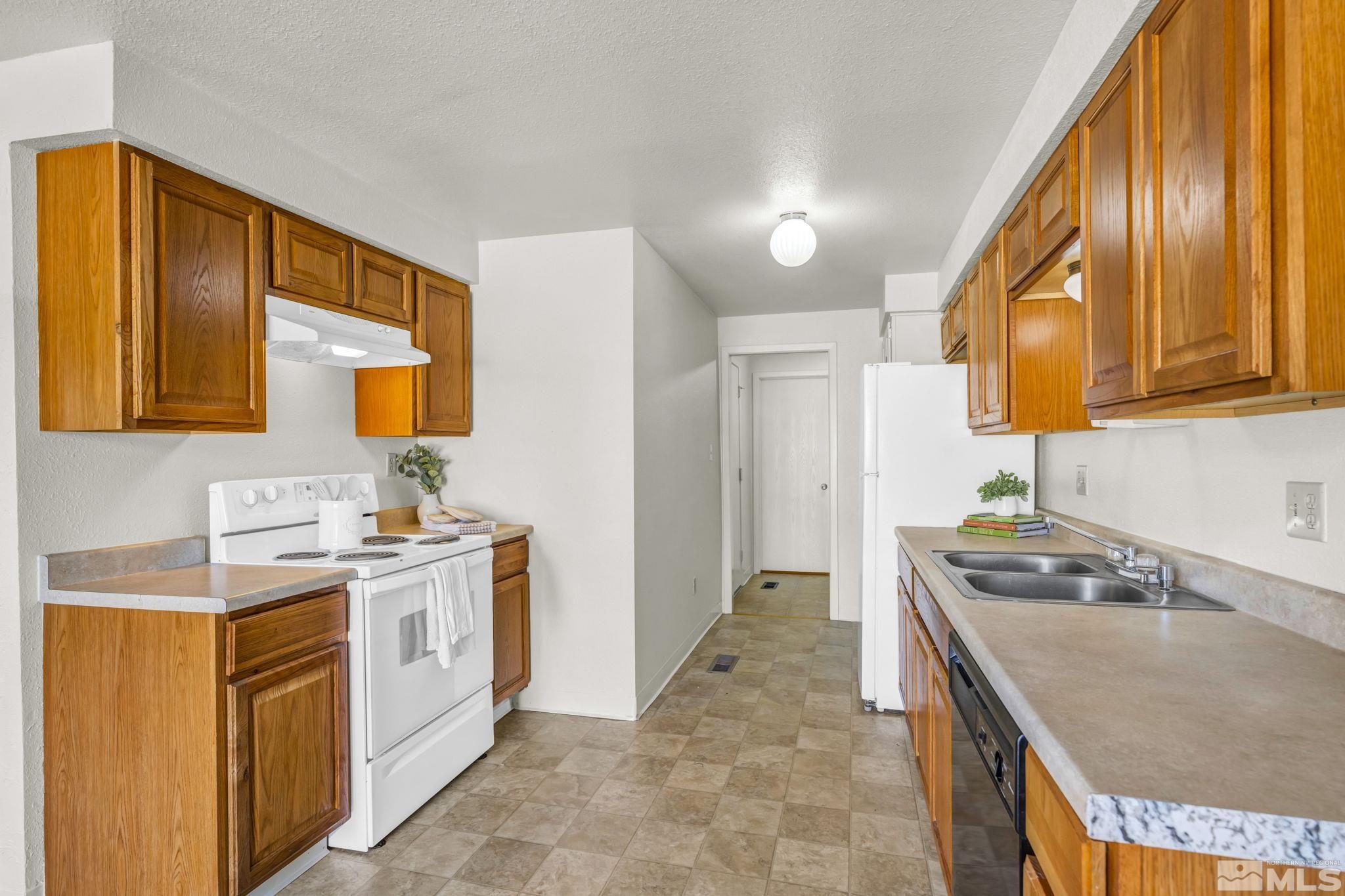 13 Condor Circle Carson City, NV 89701 - Photo 5 of 33 a kitchen with a sink a stove and cabinets