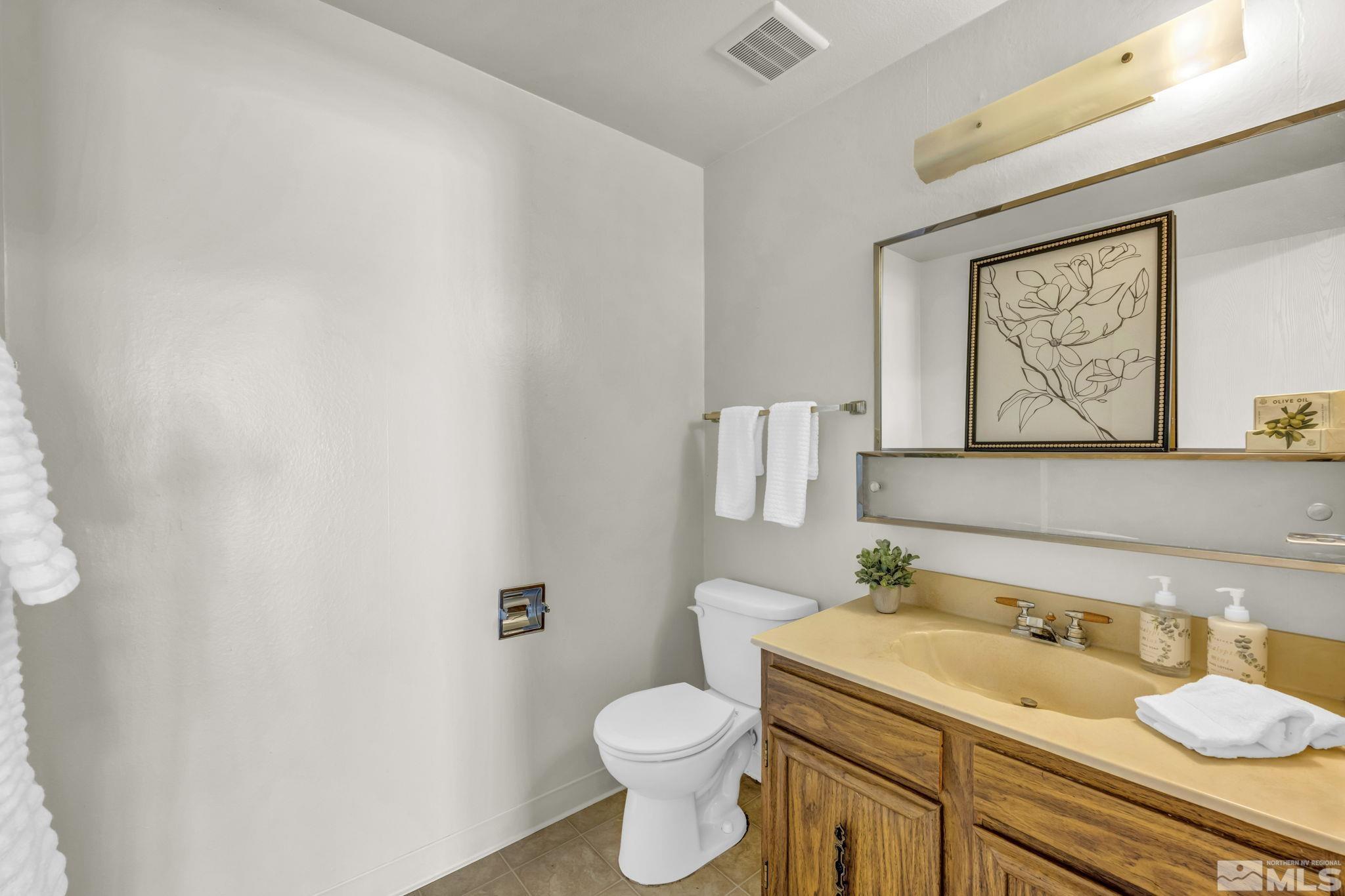 13 Condor Circle Carson City, NV 89701 - Photo 7 of 33 a bathroom with a granite countertop toilet sink and mirror