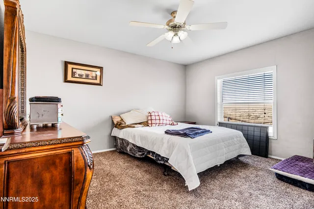 a bedroom with a bed and a rug