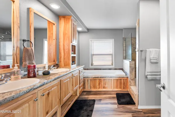a bathroom with a granite countertop shower and a sink