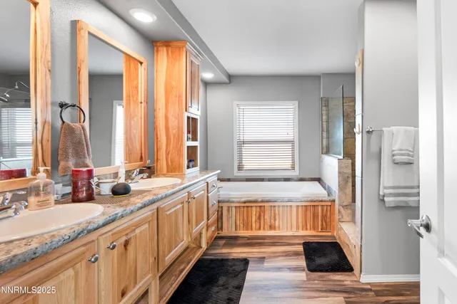 a bathroom with a granite countertop shower and a sink