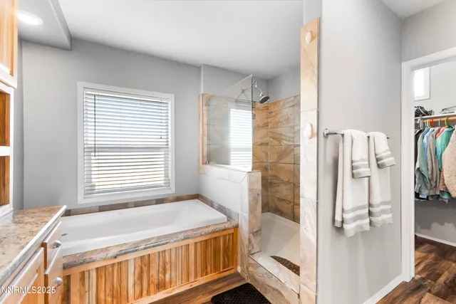 a bedroom with furniture and wooden floor