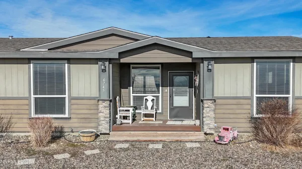 a living room with lots of furniture and a window