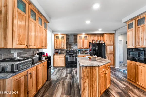 a kitchen with sink stove and view of living room