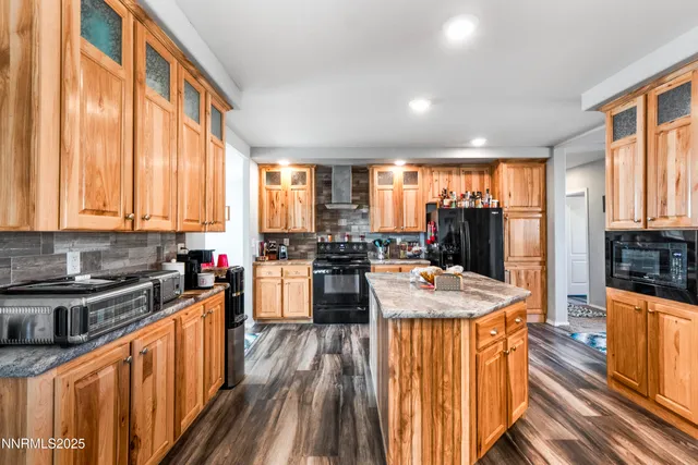 a kitchen with sink stove and view of living room
