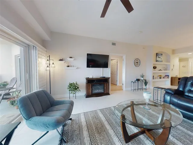 a bedroom with a bed a dresser and a chandelier