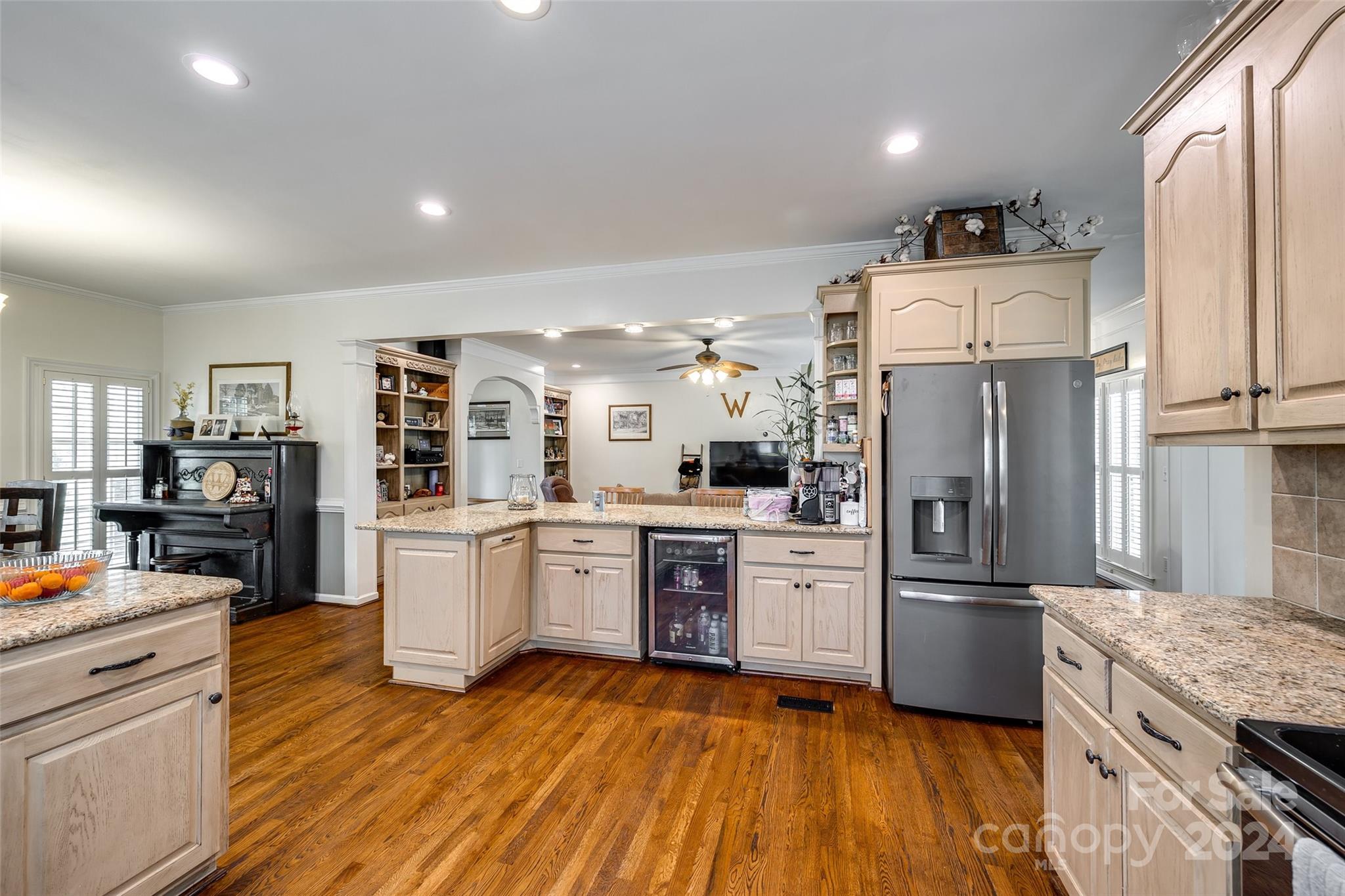 9999 Jim Sossoman Road Midland, NC 28107 - Photo 11 of 43 a kitchen with granite countertop a refrigerator oven a sink dishwasher and white cabinets with wooden floor