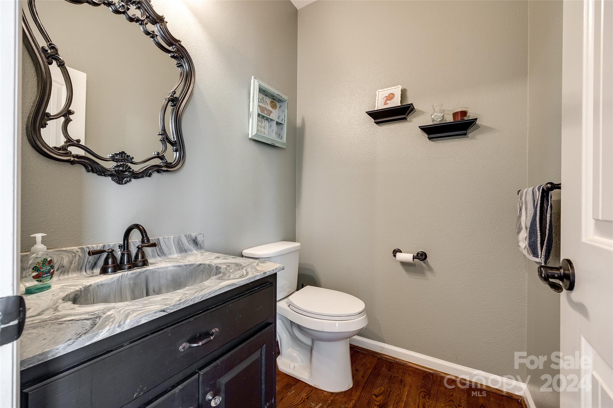 9999 Jim Sossoman Road Midland, NC 28107 - Photo 16 of 43 a bathroom with a sink a toilet and a mirror