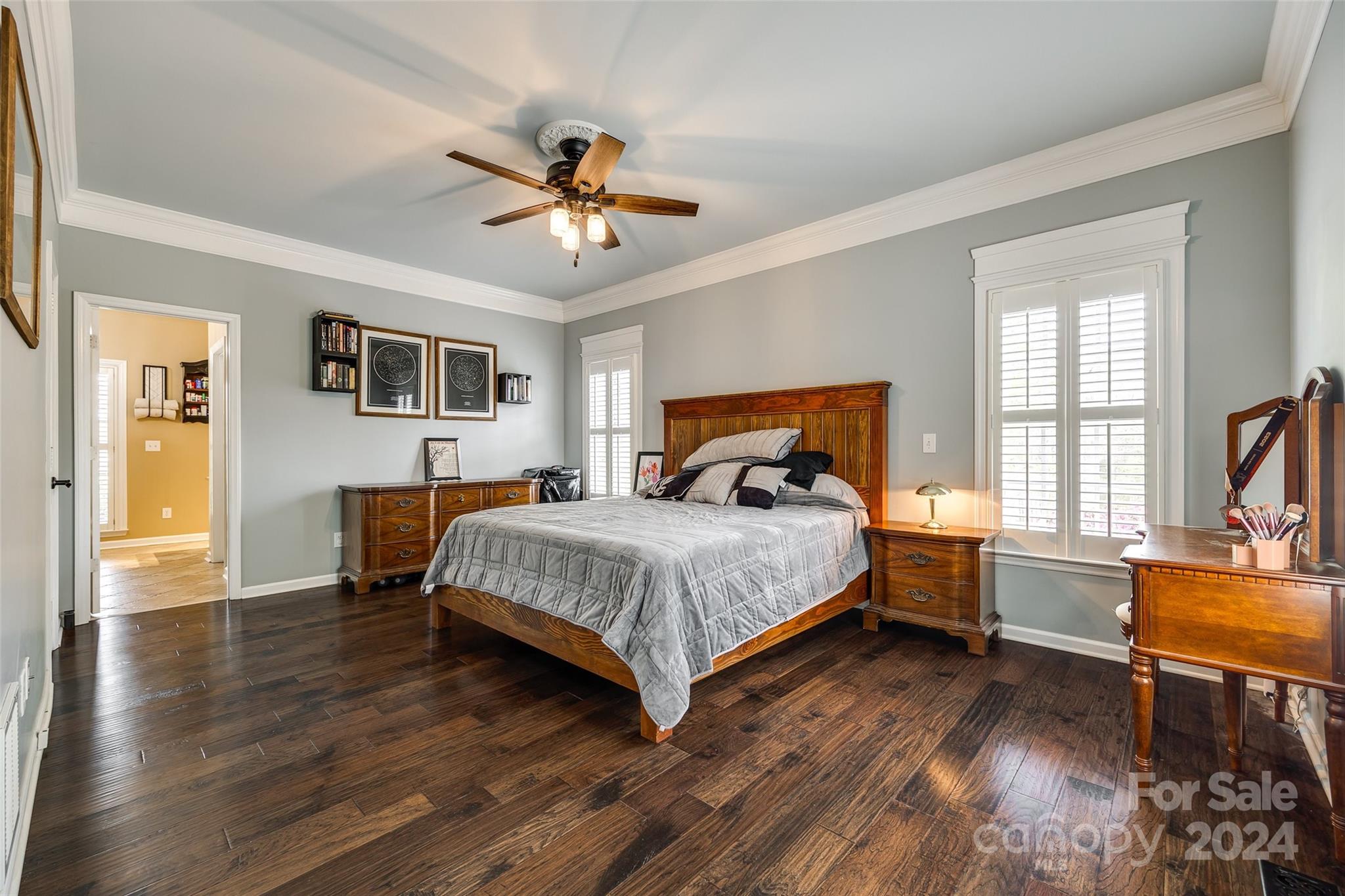 9999 Jim Sossoman Road Midland, NC 28107 - Photo 17 of 43 a bedroom with a bed a dresser and wooden floor