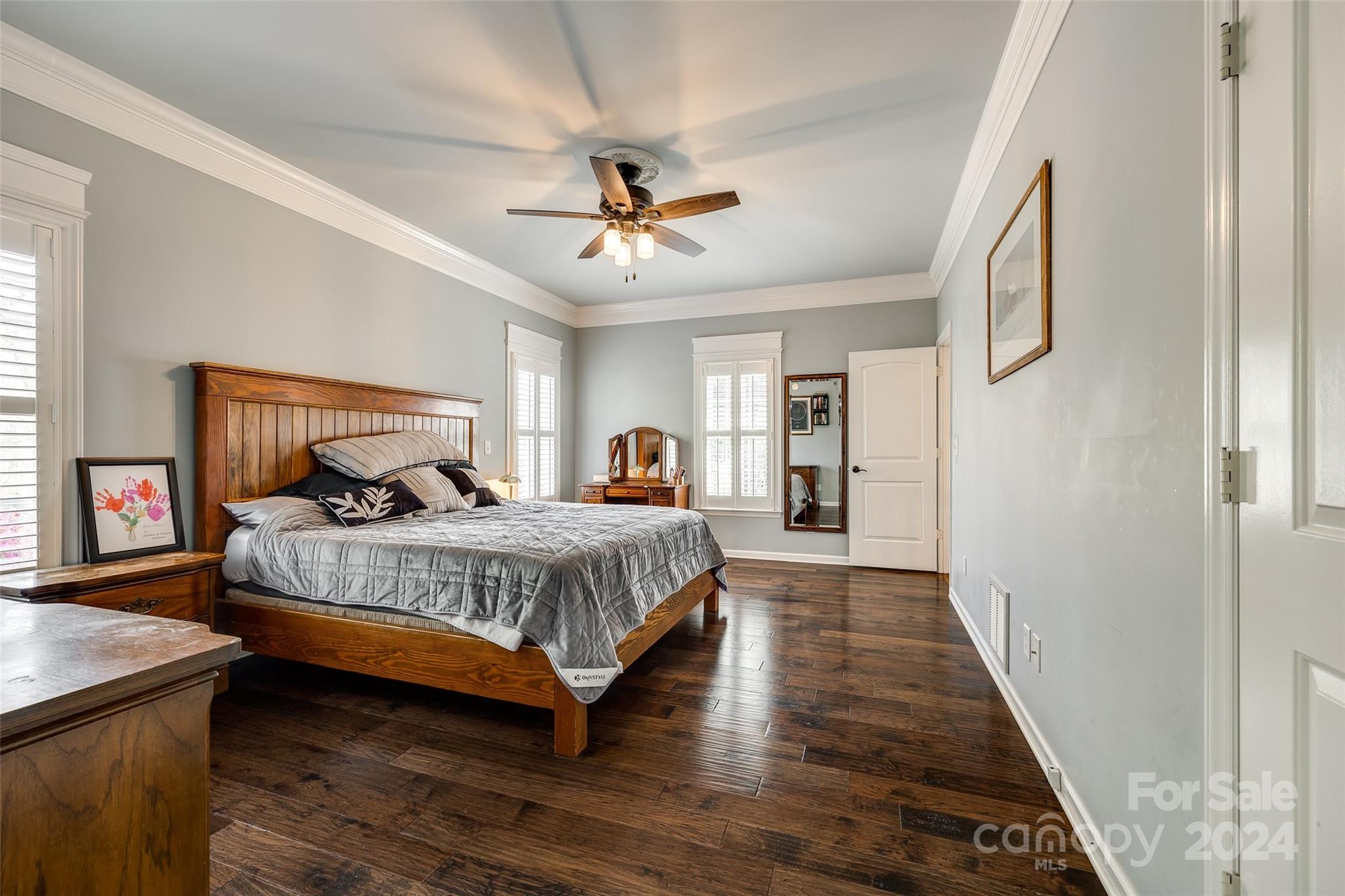 9999 Jim Sossoman Road Midland, NC 28107 - Photo 18 of 43 a bedroom with a large bed and a chandelier