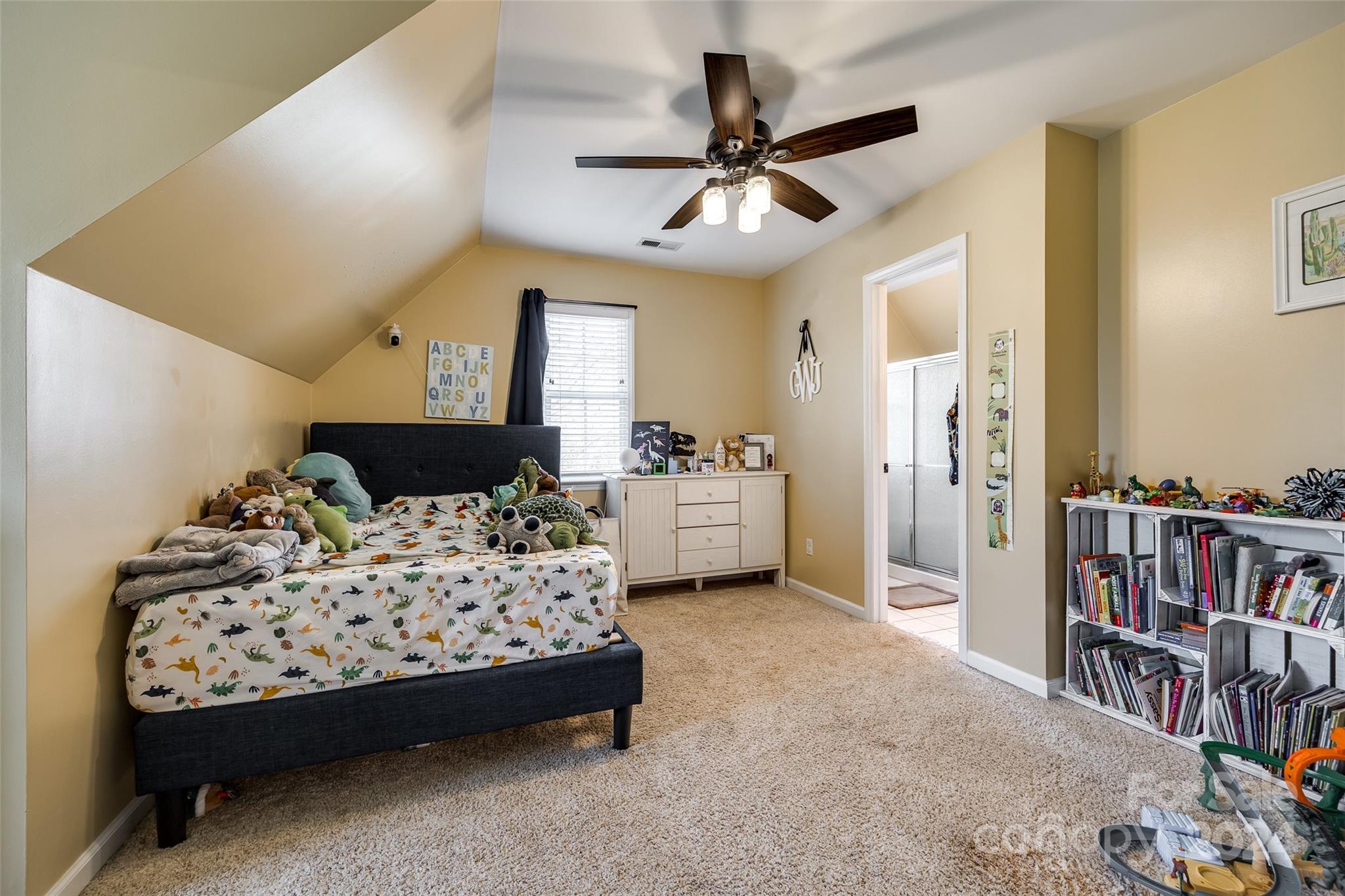 9999 Jim Sossoman Road Midland, NC 28107 - Photo 23 of 43 a bedroom with a bed furniture and a book shelf