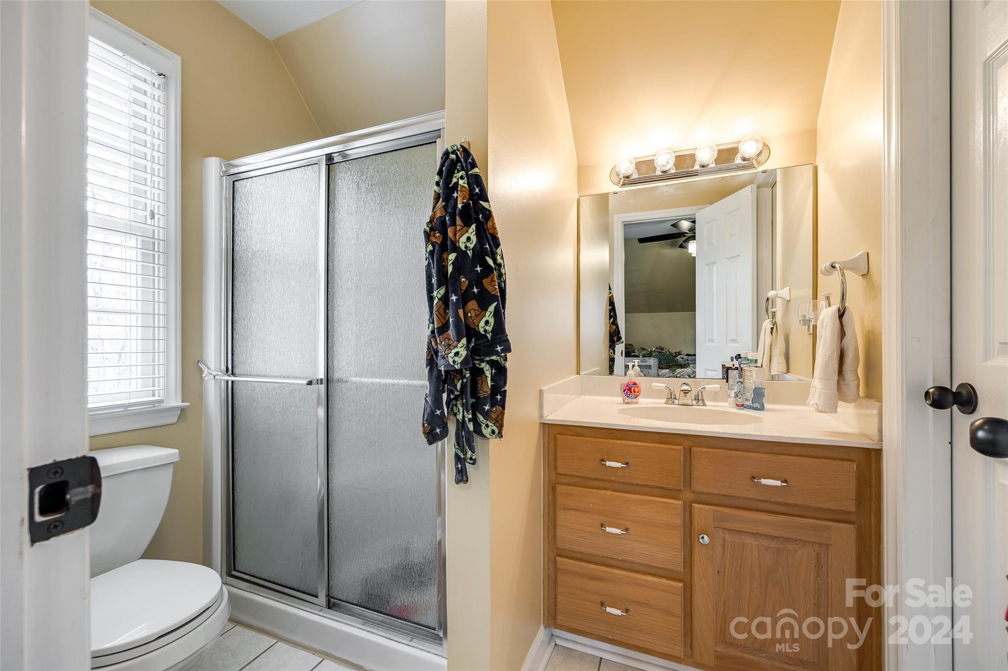9999 Jim Sossoman Road Midland, NC 28107 - Photo 25 of 43 a bathroom with a granite countertop sink toilet and shower