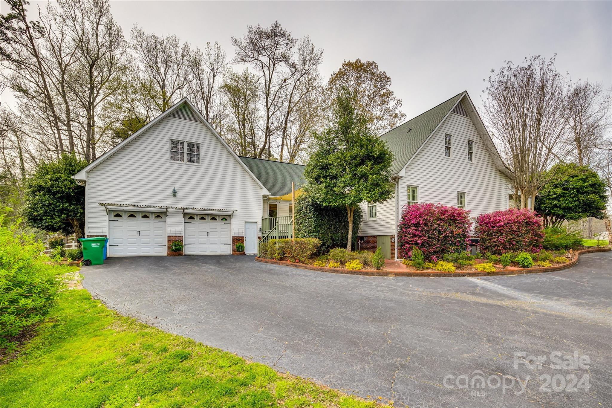 9999 Jim Sossoman Road Midland, NC 28107 - Photo 32 of 43 a front view of a house with a yard and garage