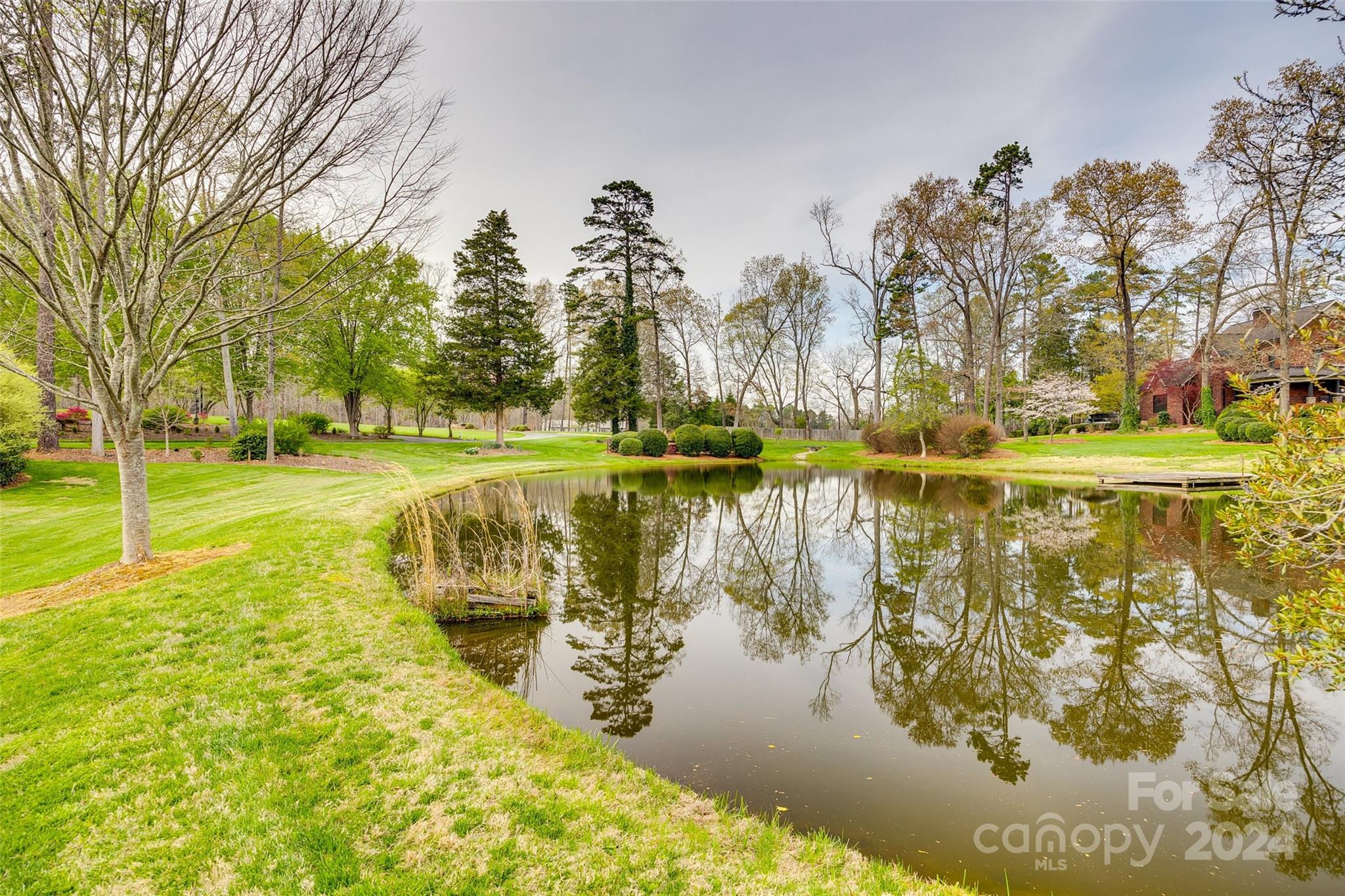 9999 Jim Sossoman Road Midland, NC 28107 - Photo 37 of 43 a view of a lake with a yard and trees