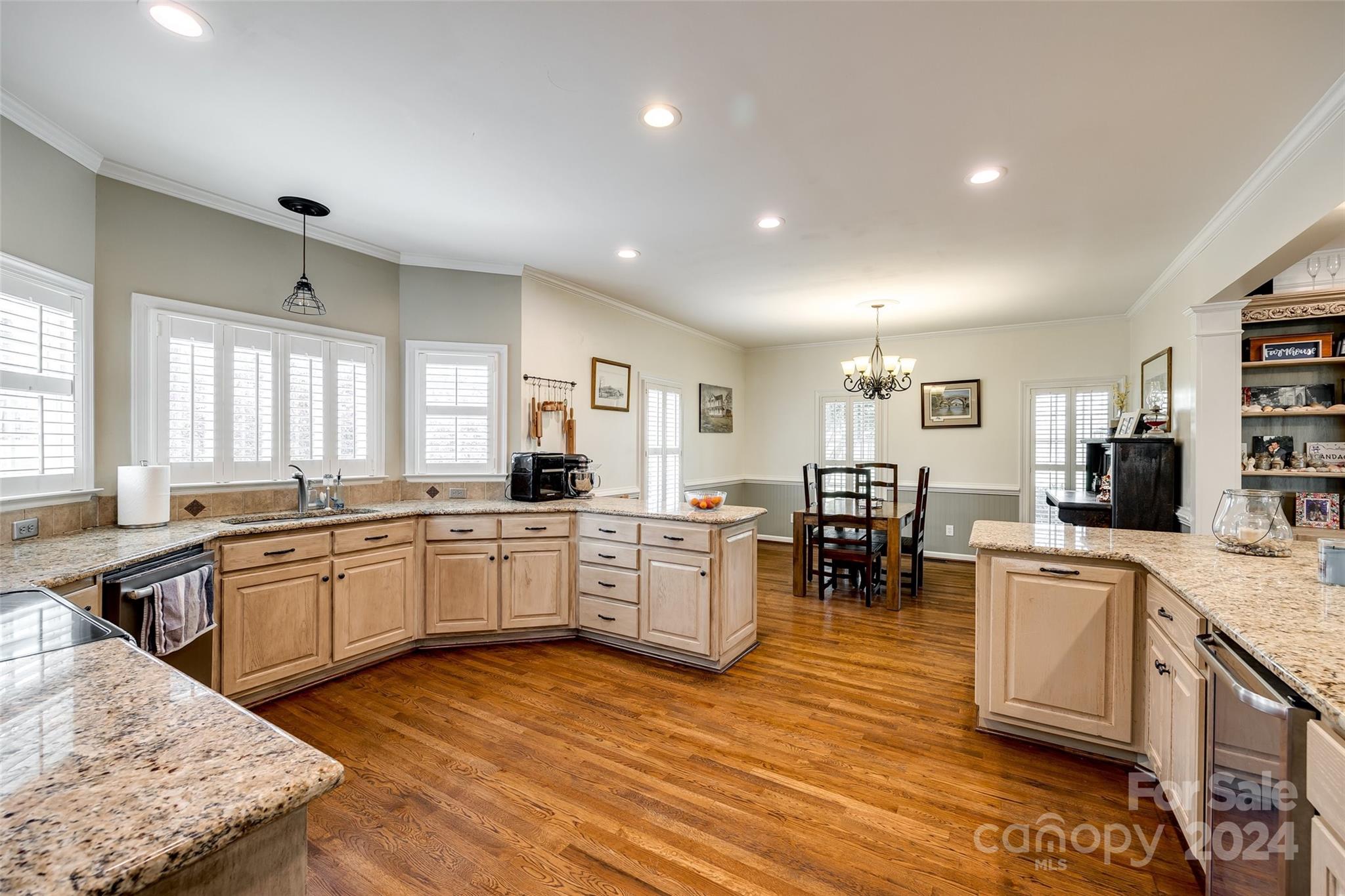9999 Jim Sossoman Road Midland, NC 28107 - Photo 10 of 43 a large kitchen with kitchen island a sink table and chairs in it