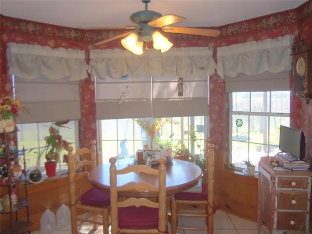 a bed sitting in a bedroom next to a lamp