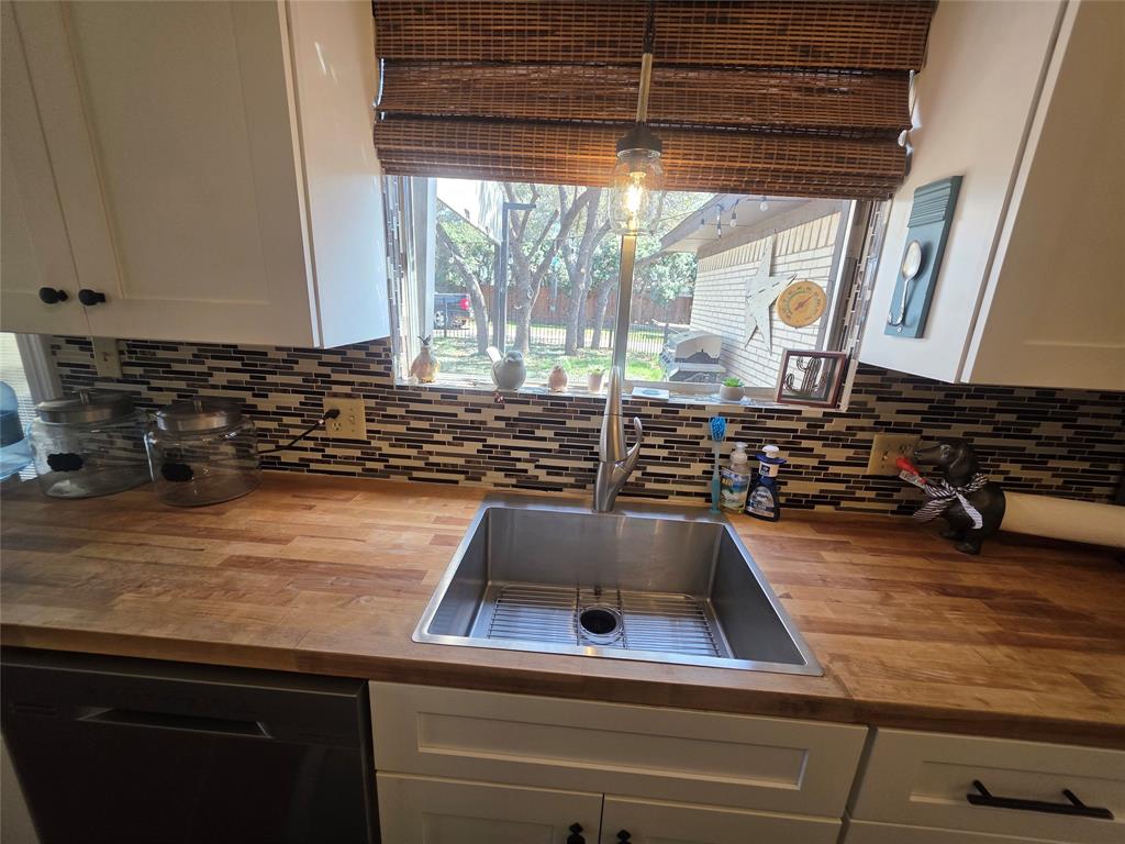 1301 Cliff Drive Graham, TX 76450 - Photo 21 of 38 a kitchen with a sink and a stove next to a window
