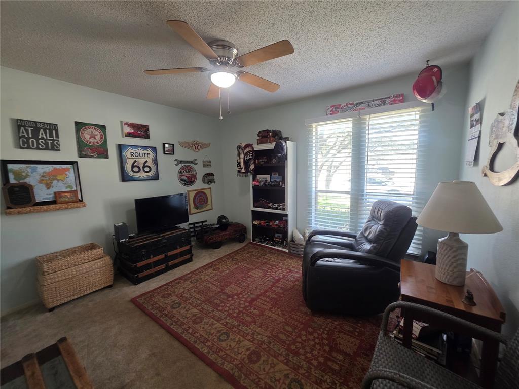 1301 Cliff Drive Graham, TX 76450 - Photo 29 of 38 a living room with furniture a flat screen tv and a window