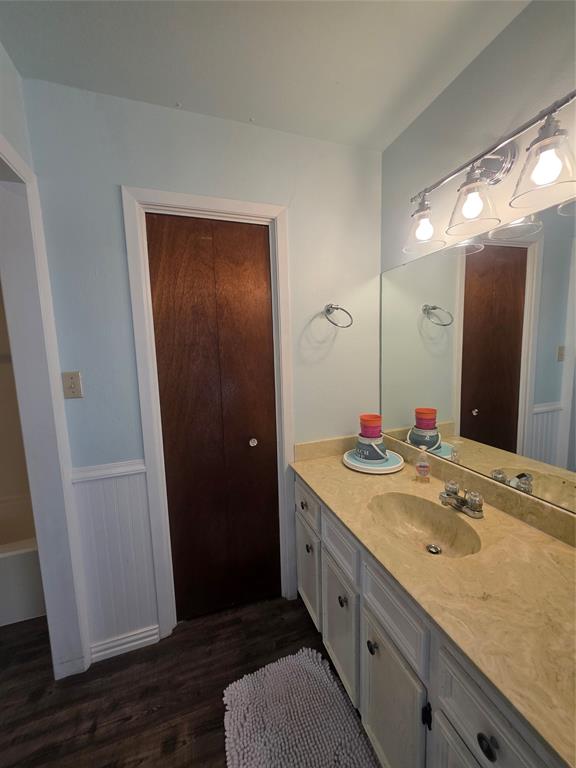 1301 Cliff Drive Graham, TX 76450 - Photo 33 of 38 a bathroom with a granite countertop sink and a mirror