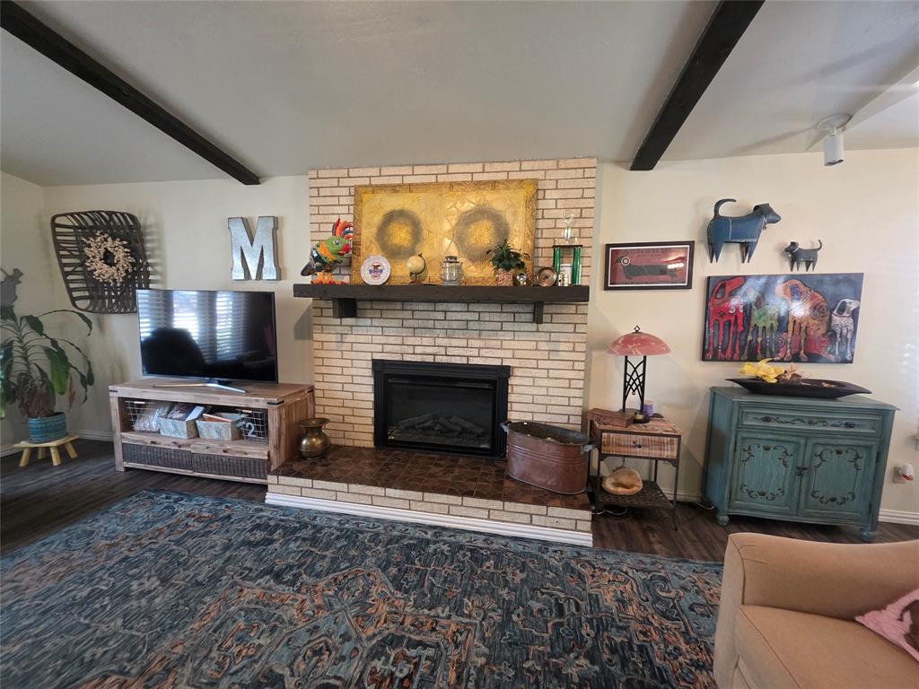 1301 Cliff Drive Graham, TX 76450 - Photo 10 of 38 a living room with furniture a flat screen tv and a fireplace