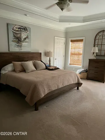 a bedroom with a bed couch and window