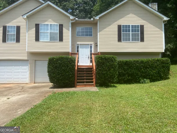 a view of a house with a yard and garage