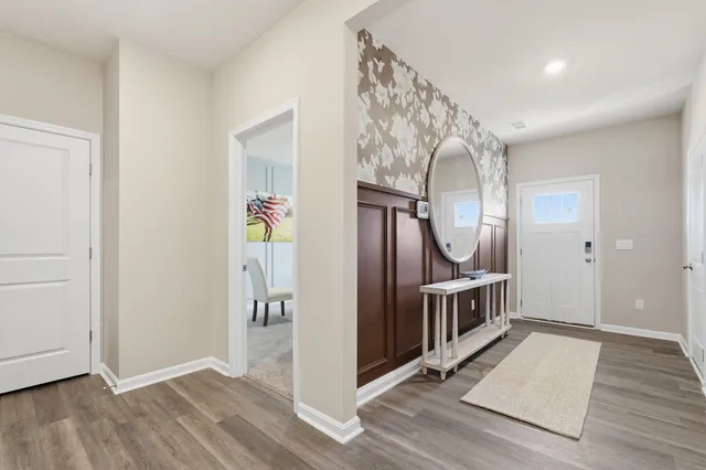 a view of a hallway with wooden floor and staircase