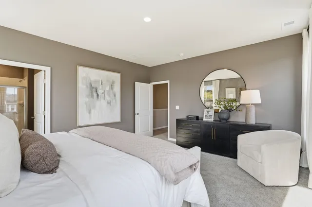 a bedroom with a bed and a mirror