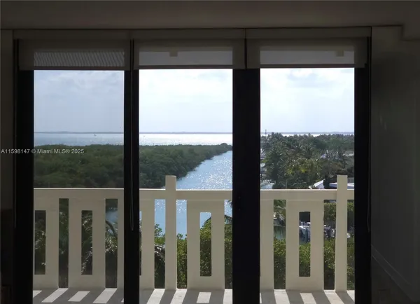 a view of a glass door with a yard from a window