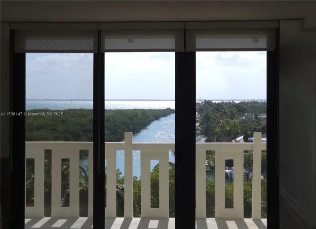 a view of a glass door with a yard from a window